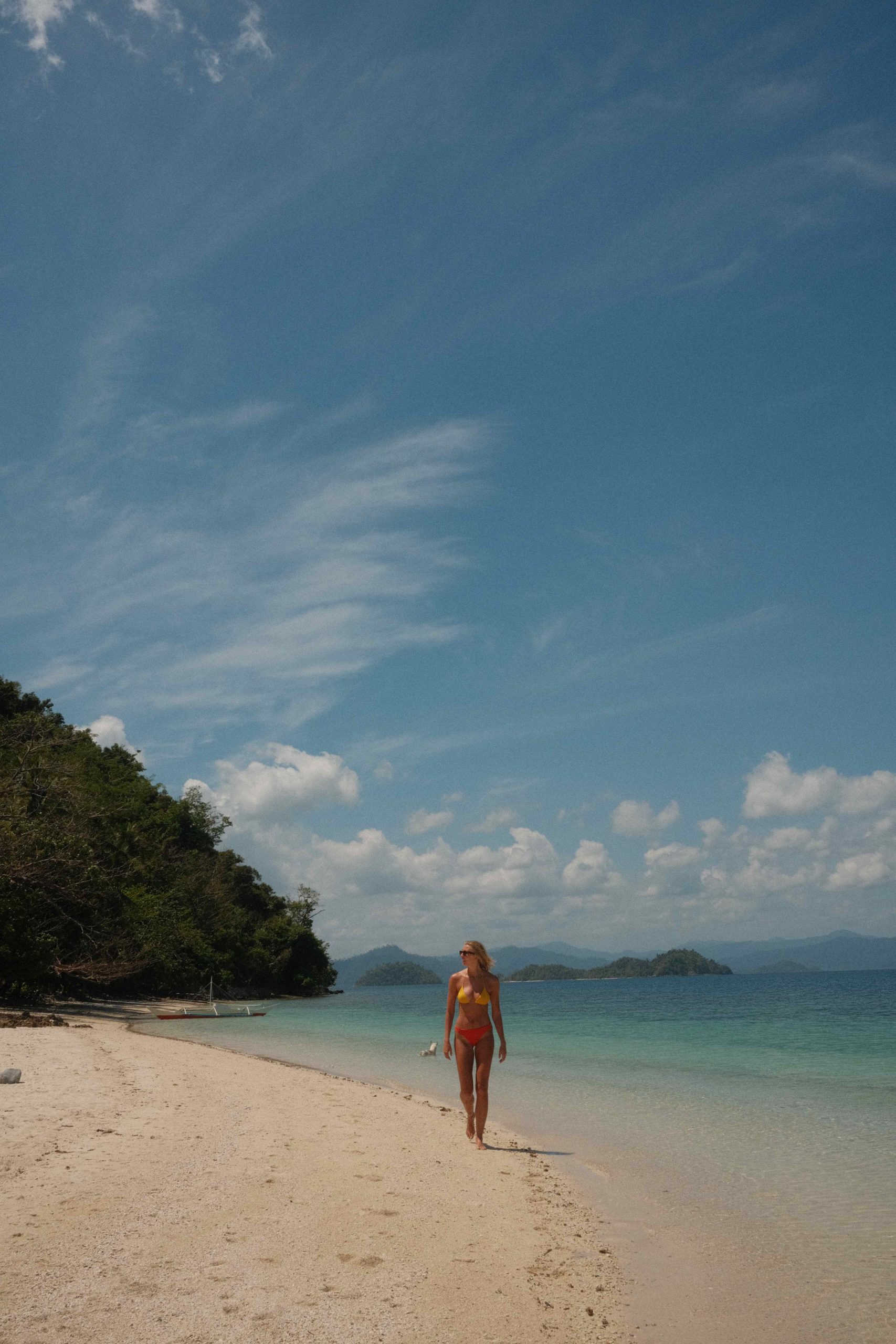 Zanna van Dijk walks along a strip of beach in the Philippines